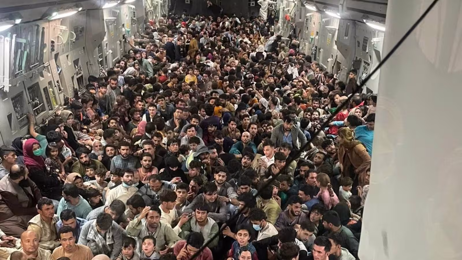 Hundreds of Afghans pack US military plane in desperate effort to escape the Taliban